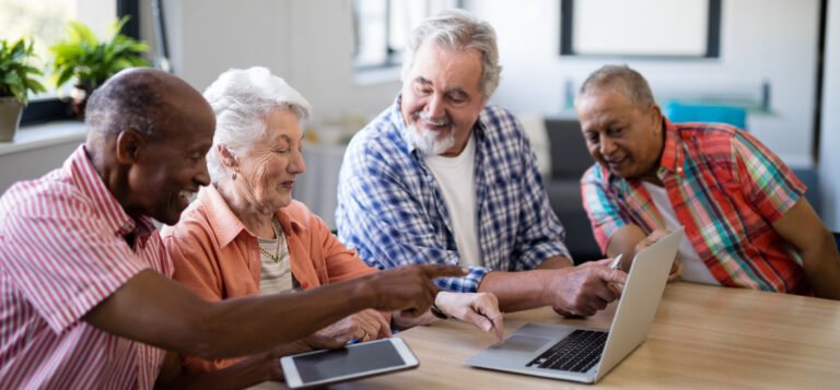 people looking at a laptop and tablet