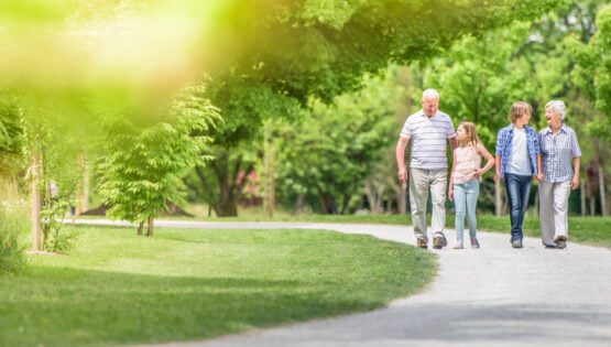 Grandparents and grandchildren walking at park