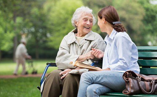 Senior woman with caregiver in the park