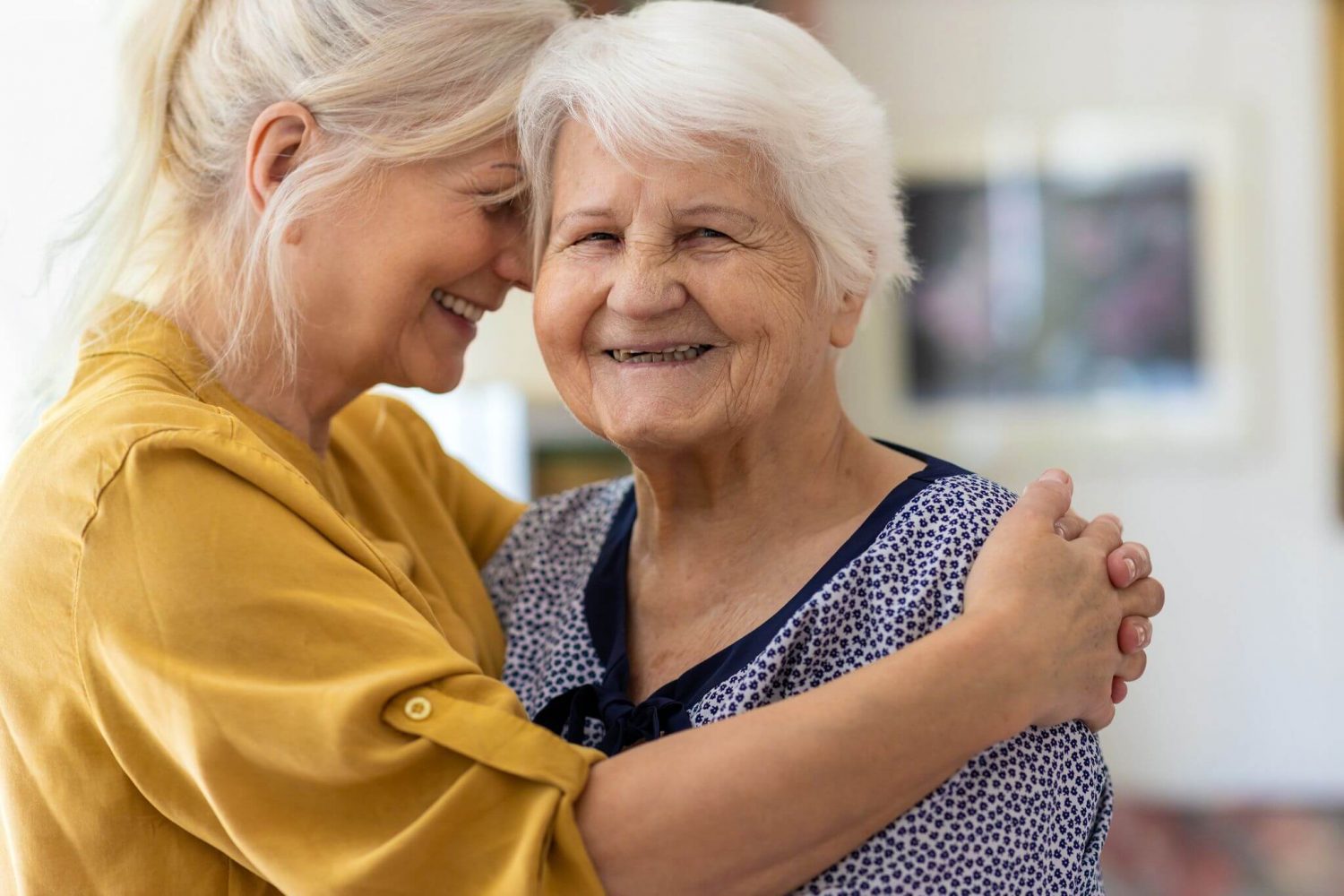 A woman is embraced by her adult daughter