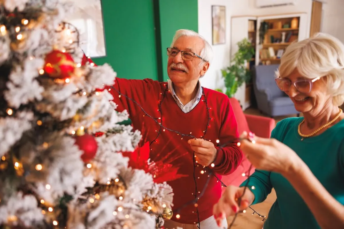 Couple of older adults decorating their Xmas tree - Rockbridge Oaks Couple of older adults decorating their Xmas tree