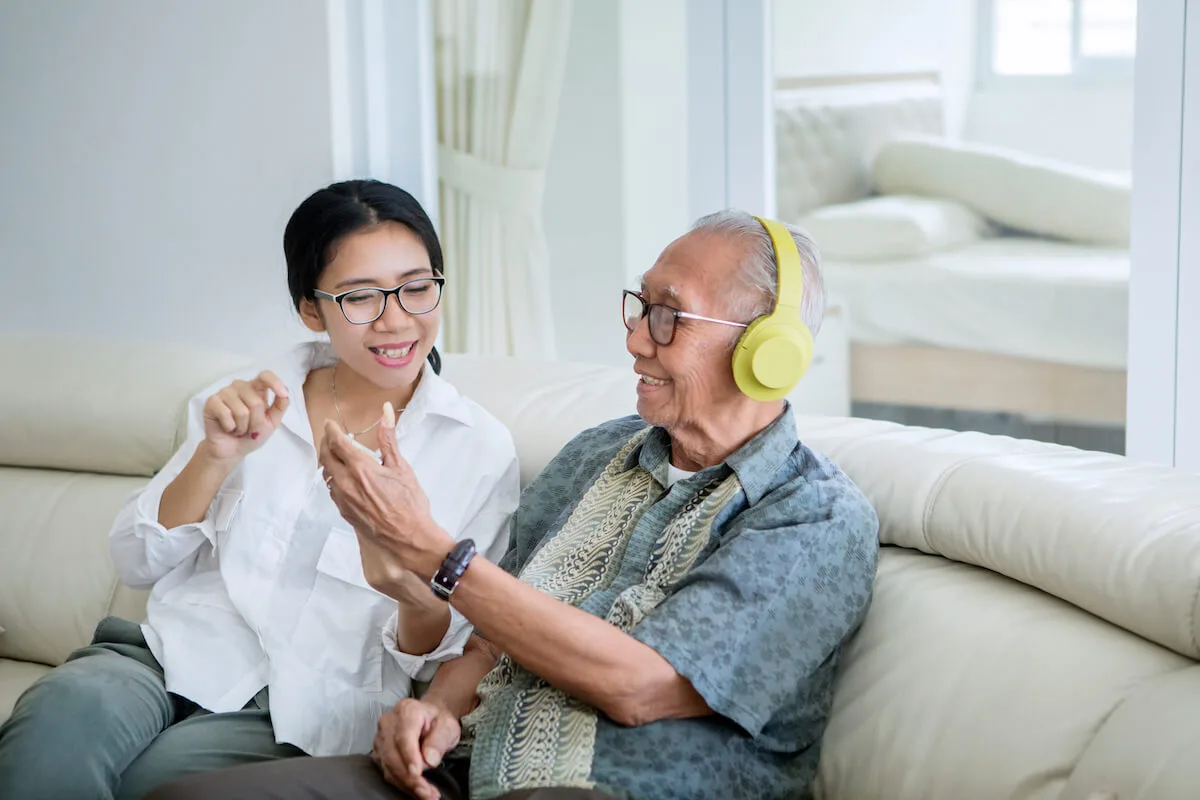 music therapy caregiver - Rockbridge Oaks Adult daughter showing his dad a phone