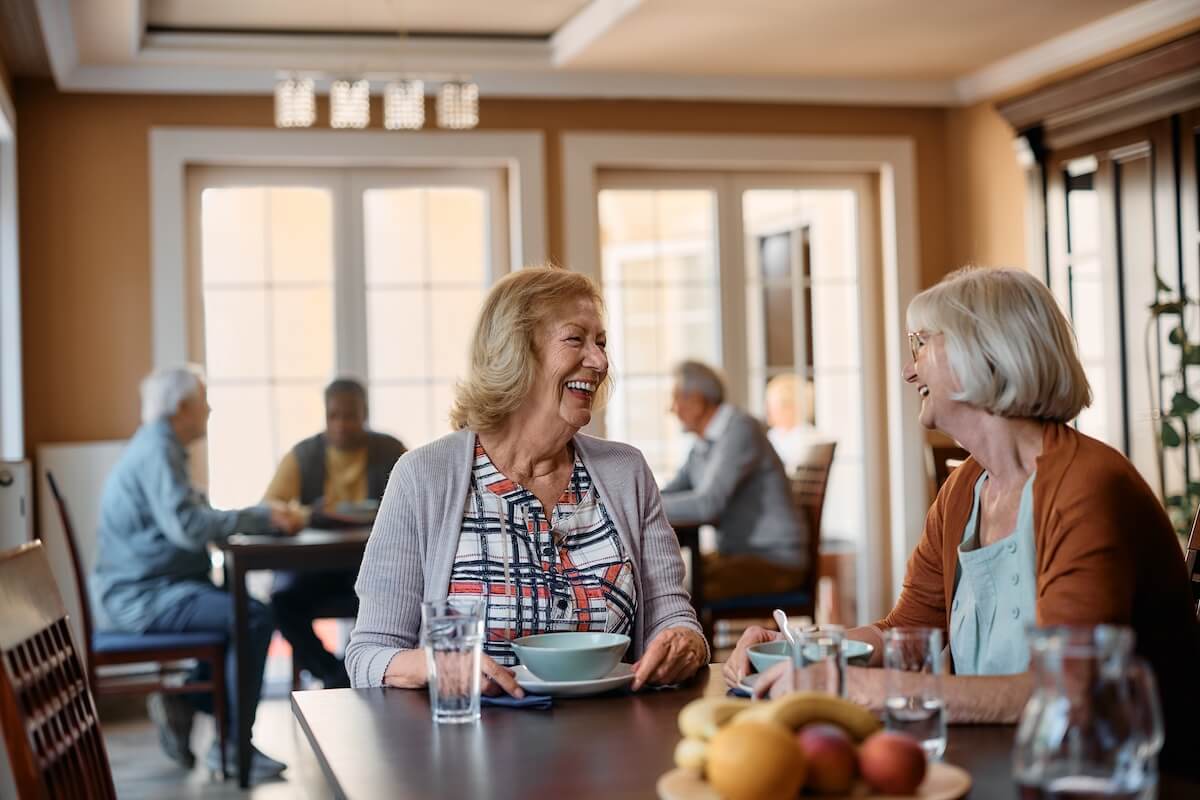 dining - Rockbridge Oaks Older adults sharing a meal in a senior living community