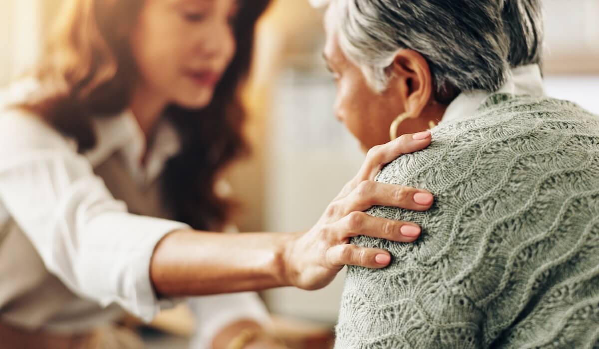 Older woman getting grief support in a senior living community