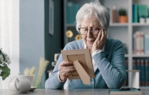Lonely older woman looking at picture
